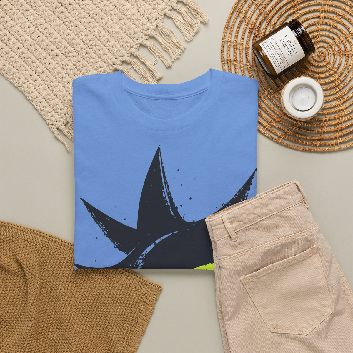 Signal Eye Tee in Carolina Blue, flat lay with jeans