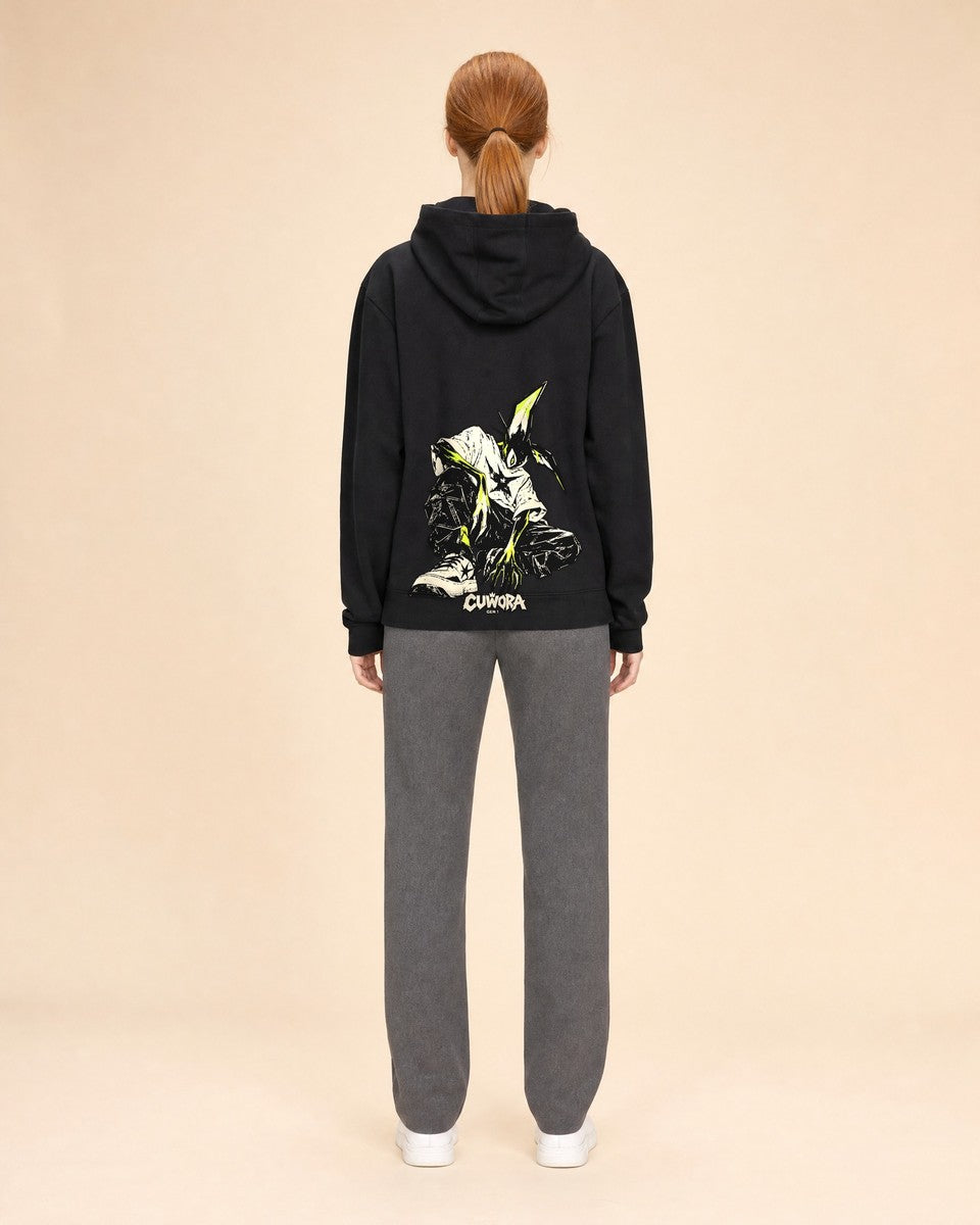 Model wearing the Signal Creature Hoodie in Black, back view with the crouched creature print in bone and acid lime