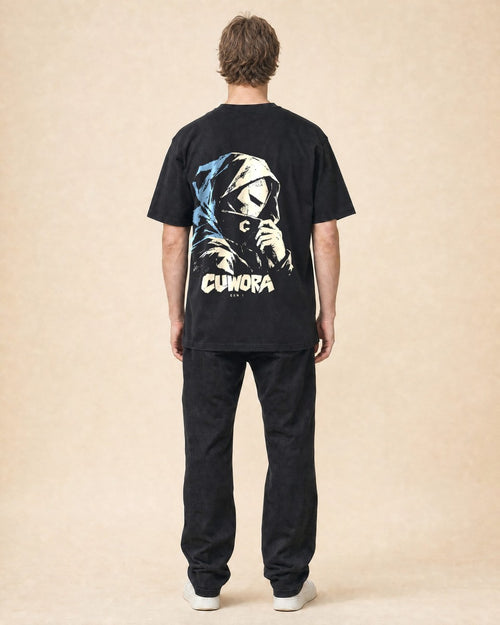 Model wearing the Hooded Portrait Tee in Black, back view with the hooded portrait print in bone and dusty blue