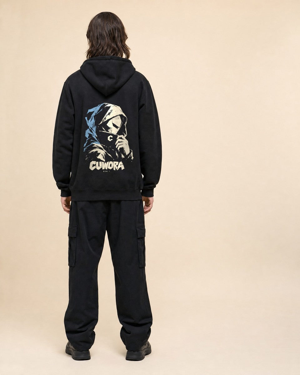 Model wearing the Hooded Portrait Hoodie in Black, back view with the hooded portrait print in bone and dusty blue